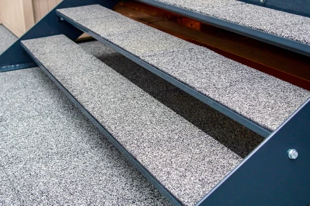 A staircase in an outdoor area made weatherproof and safe by WARCO stair covering.